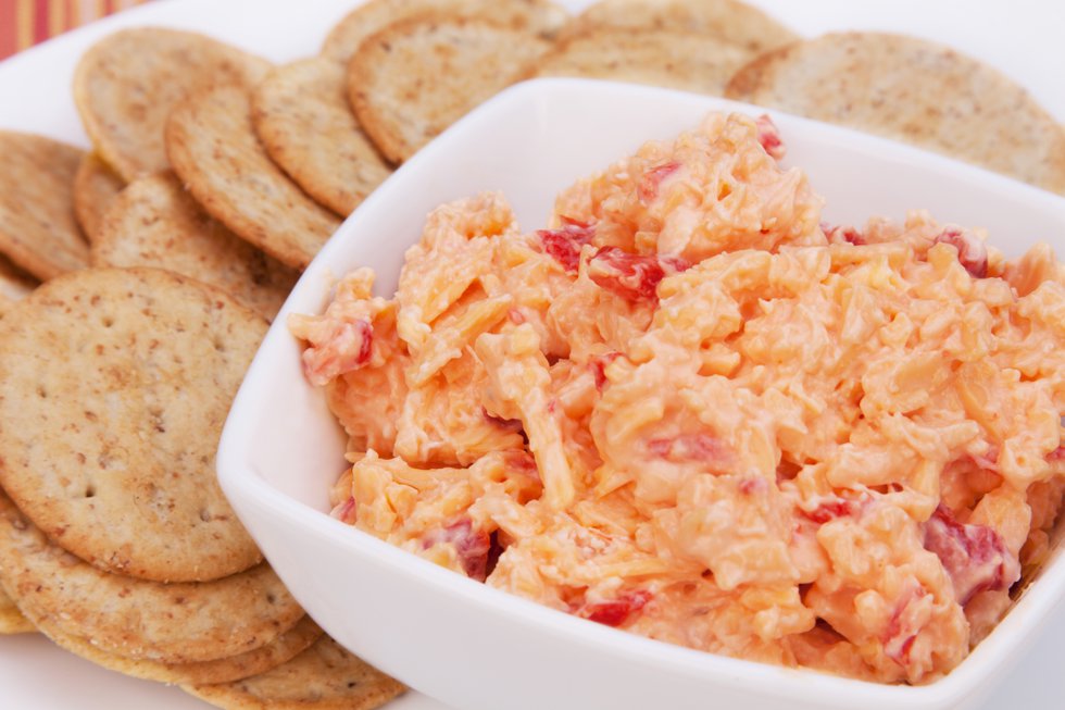 Pimiento Cheese Spread and Crackers – A Southern favorite, pimiento cheese spread. Wheat crackers in the background.