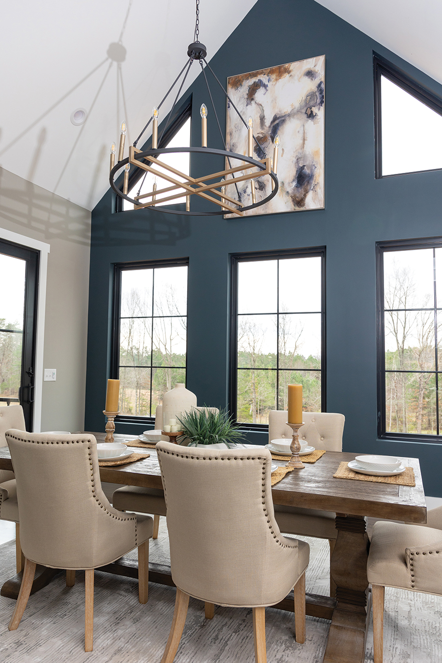 Traditional meets modern with tufted seating and candelabras in the dining room.