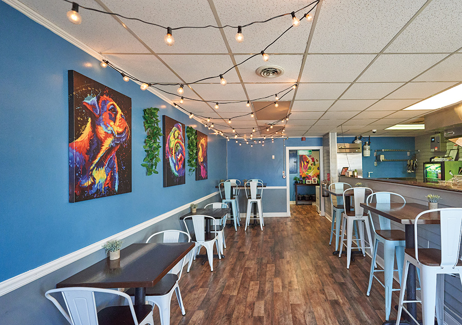 Lazy Bulldog's interior exudes a cool, fun vibe with painted bulldog portraits and party lights.