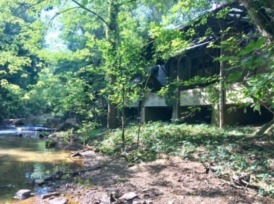 Pictured is the current state of the back of the structure that is located on the banks of Glade Creek.