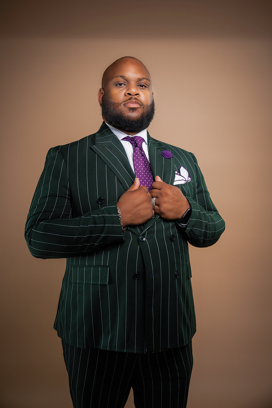 Pastor Jay Hamm looks resplendent in his well-accessorized pinstripe suit. He serves as a clothing consultant for men at the Garden of Prayer #7 Church in Roanoke.