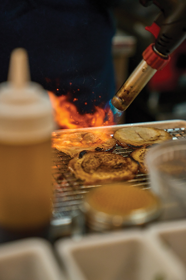 Torched-to-order char siu pork belly brings a smoky, savory hit to ramen and bao.