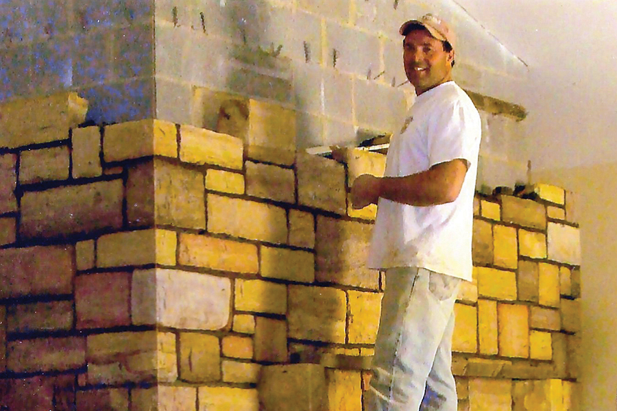 Kelly Francisco building a chimney at his home.
