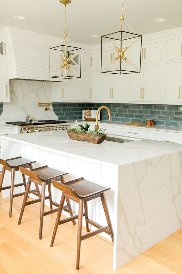 Gorgeous countertops and a backsplash of color modernize this gorgeous kitchen.