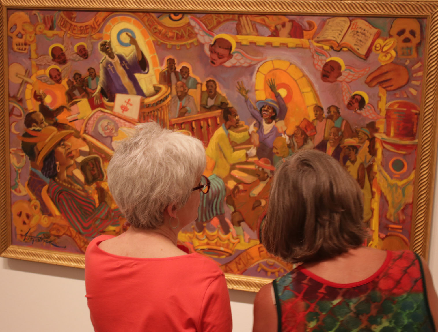 Margie Herring (left) and Becky Hepler admire a Fitzpatrick painting.