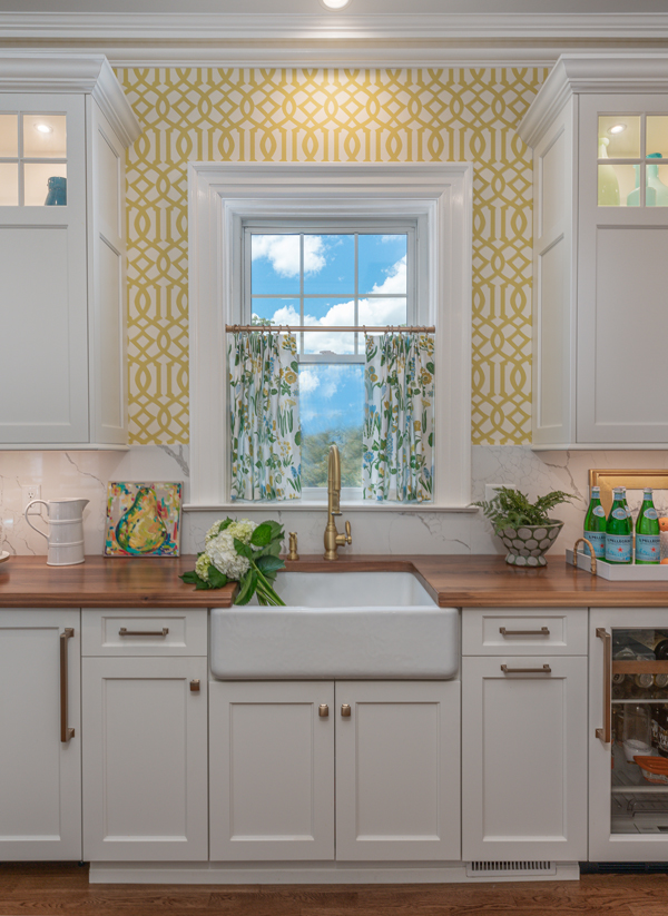 Edith-Anne Duncan built the range wall around the bistro shelves, which are airy and timeless, and allow the homeowner to display favorite treasures, photos and kitchen items.