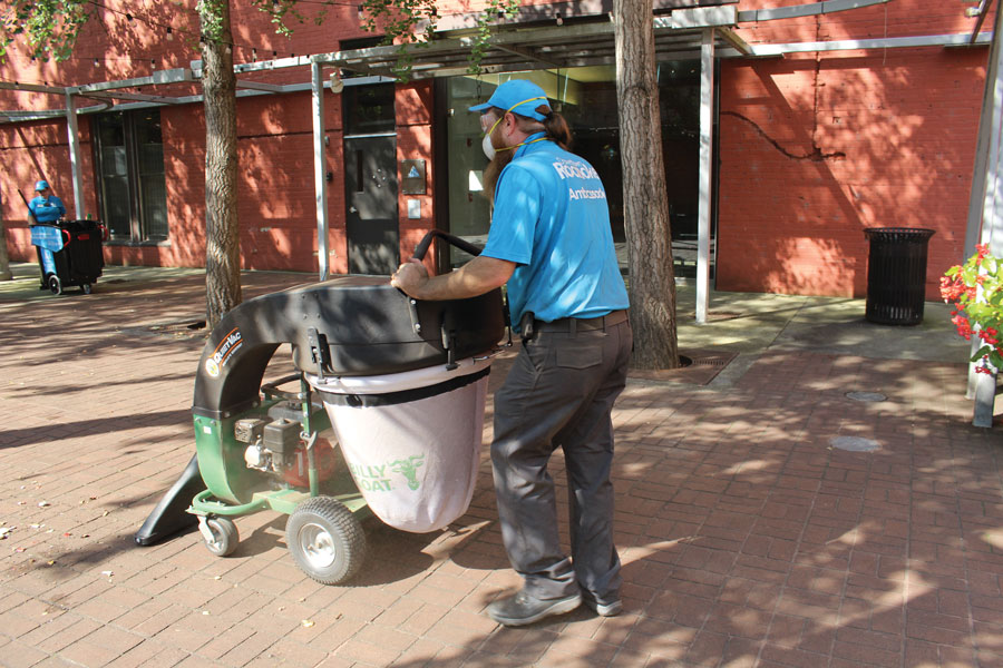 The cleanup crew collects litter and weeds, and power washes spaces.