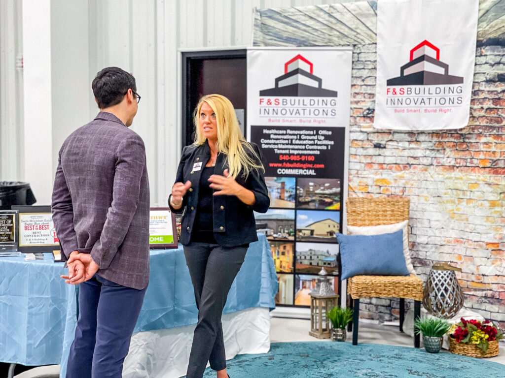 Alicia Smith with F&S Building Innovations speaks to a prospective customer at the Smith Mountain Lake Business Expo on Oct. 15 at EastLake Community Church.