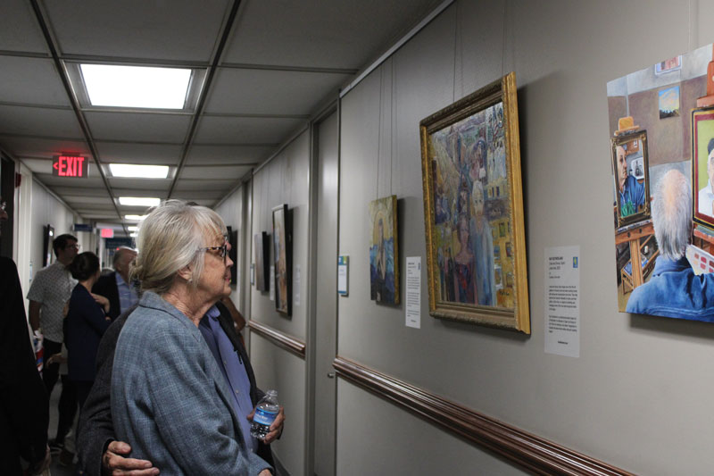 Attendees view artwork on the first floor of the Noel C. Taylor municipal building.
