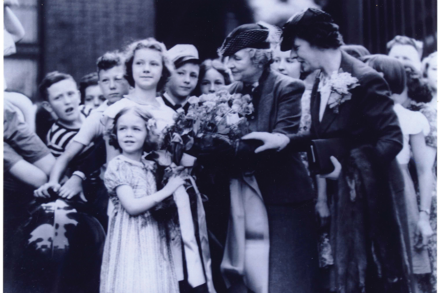 Schoolchildren greet Helen Keller (middle, receiving a floral bouquet) at the N&W Railway station in Roanoke in May 1939. Betty Gill is presenting the bouquet to Keller.
