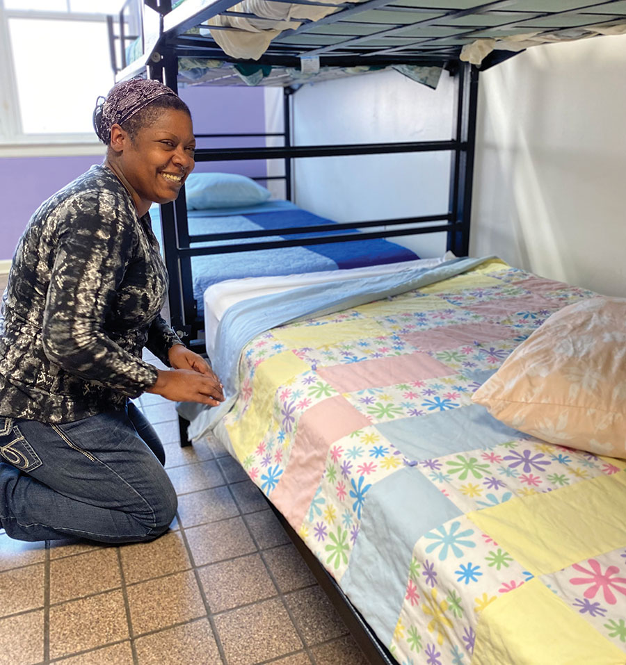 A guest makes a bed at the Rescue Mission.