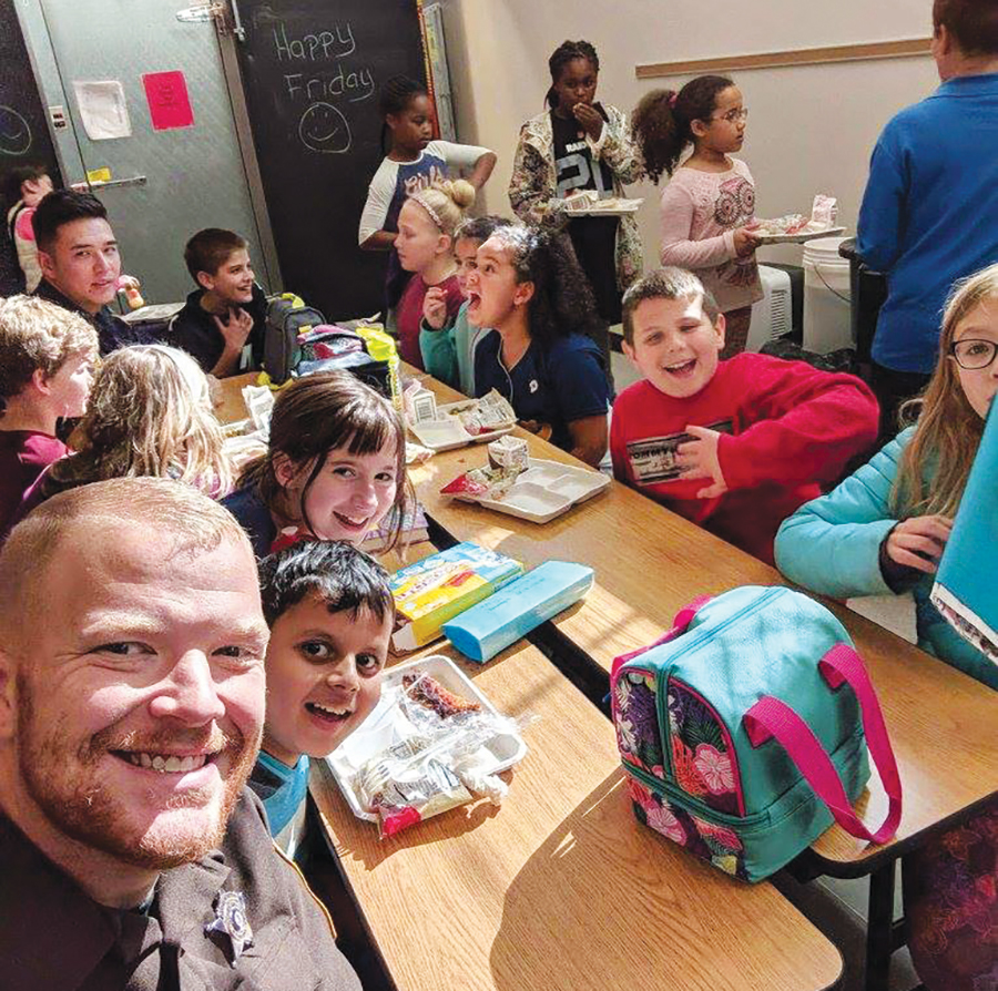 Officer Matthew Kelly interacting with students at Virginia Heights Elementary School.
