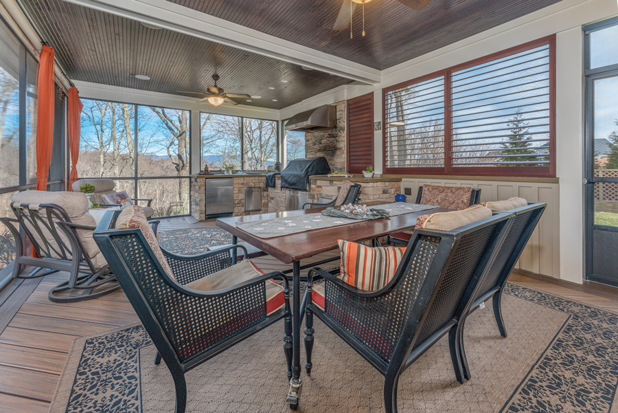 The home boasts multiple outdoor spaces, like a screened porch with full outdoor kitchen and a firepit for cool evenings.