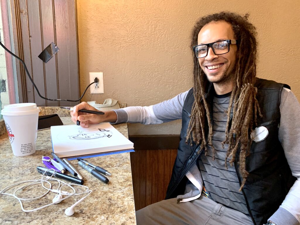 Evan Thomas Niemann sketching in one of his favorite spots: Mill Mountain Coffee & Tea.