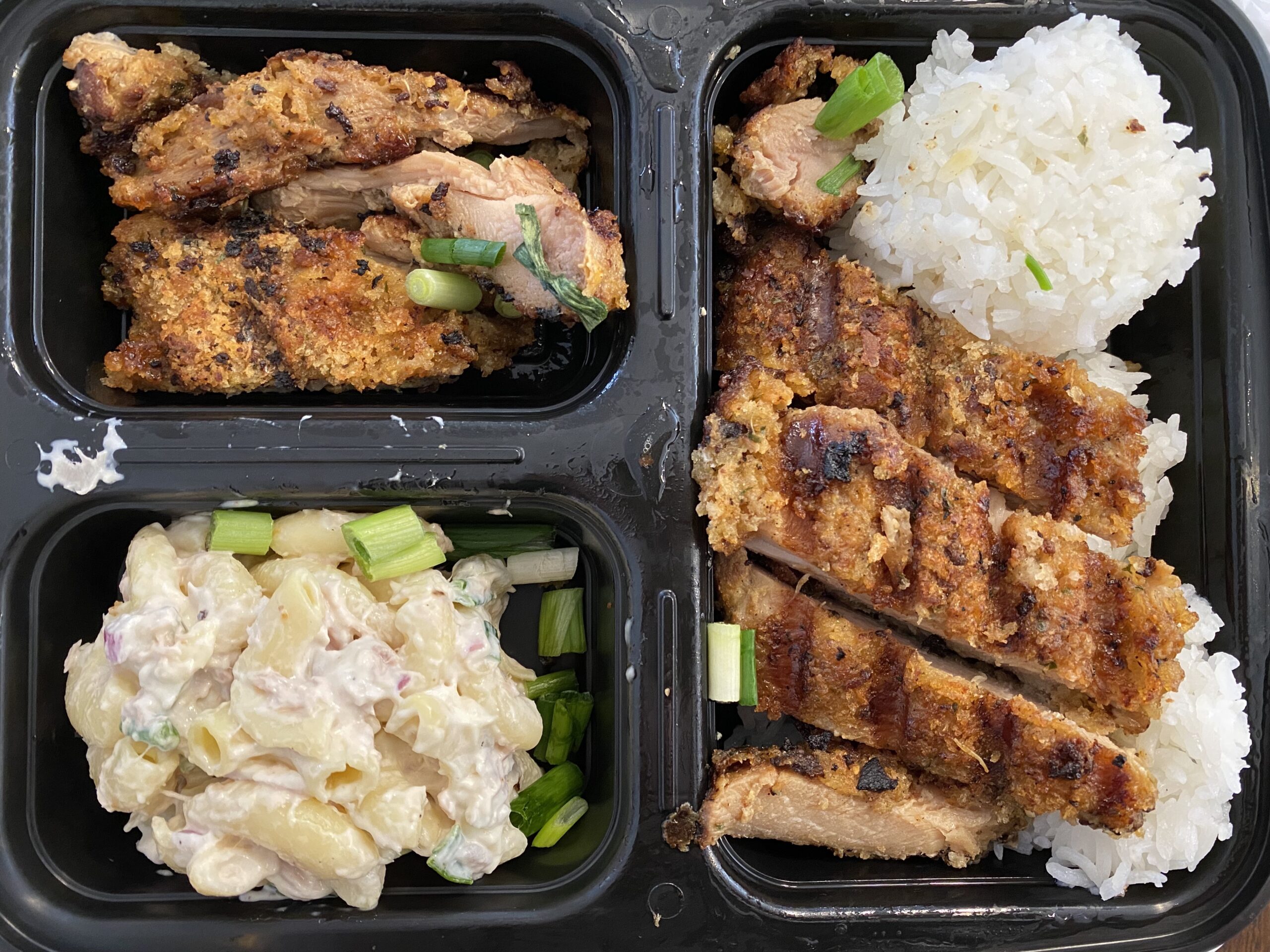Chicken katsu on jasmine rice, complete with savory-tangy dipping sauce and a scoop of mac salad.