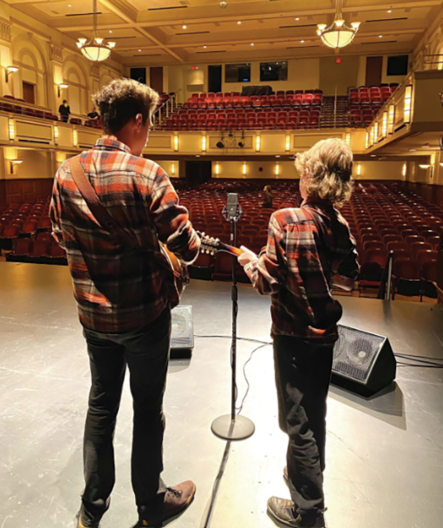 Ayden and Blane stand on the Jefferson Center stage, preparing to perform at the Blue Ridge Jamboree: ON THE RISE Showcase 2023