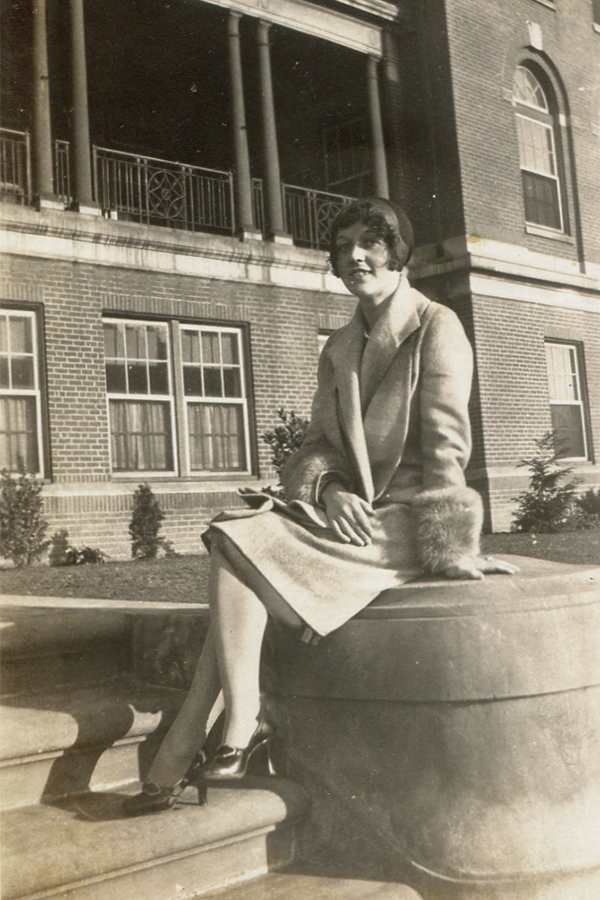 Vesta Sutphin poses on the front steps of Hill Crest Hall in this 1930s image.