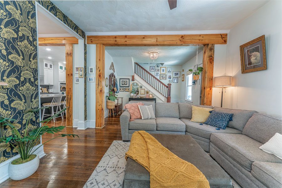 Exposed wooden beams and brick wall add to the natural elements that combine both classic and modern touches.