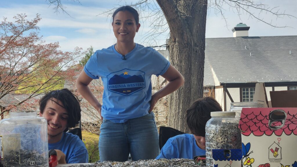 Virginia Western students Nikko Maiolo (from left), Briana Wood and Nate Girardeau help film the video for their entry in the Community College Innovation Challenge outside the Ronald McDonald House this spring.