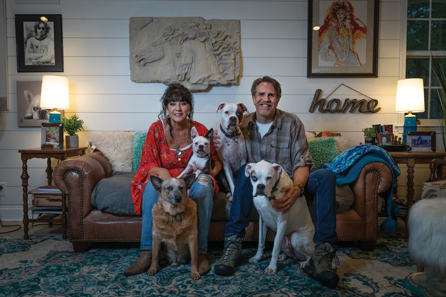 Chris and Christina Lee in their Salem living room with their deaf dogs. The dogs, from left to right, are Cornell, Bowie, Bud and Nitro. Nitro passed away last November.