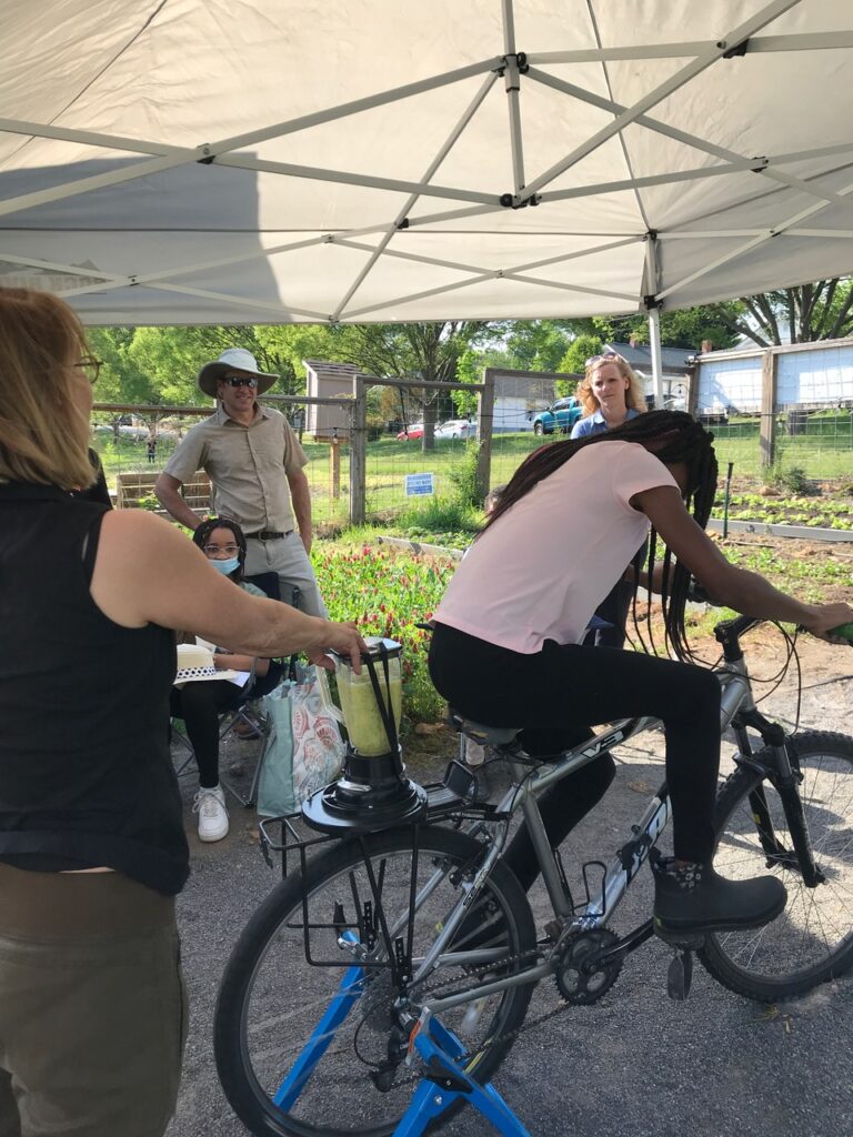 Teens at the Boys and Girls Club of Southwest Virginia make smoothies (powered by riding a bike) from ingredients they helped grow in Morningside Urban Farm, a Carilion Clinic project, run by farmer Cameron Terry.