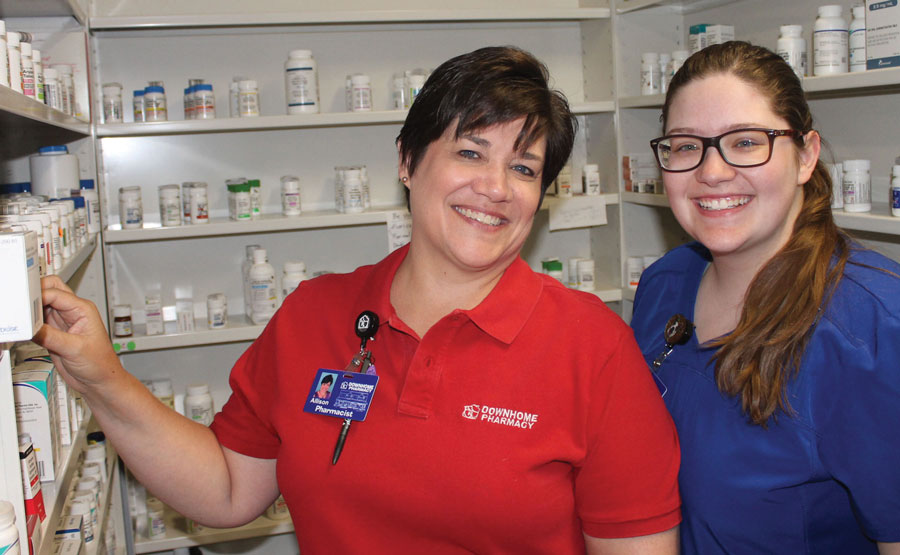 Allison (right) and Kendall Lucas at the pill shelves.