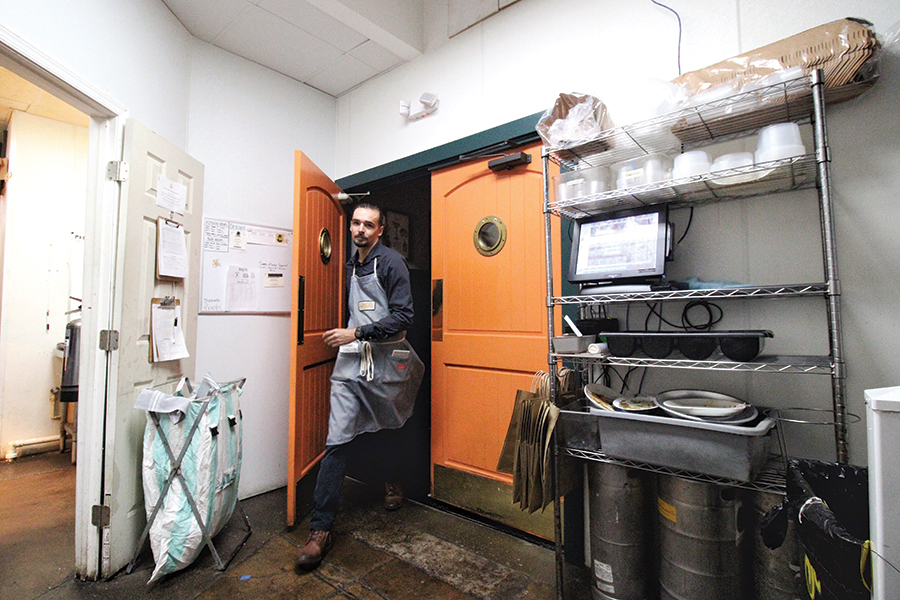 Zac Shifflett rushes into the kitchen, on his way to pick up an order.