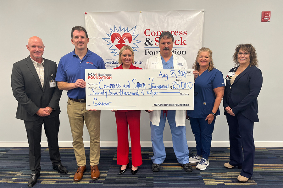 LewisGale Medical Center and HCA Virginia leaders celebrate a $25,000 grant award to The Compress and Shock Foundation, a Roanoke based nonprofit promoting AED education and accessibility. The grant will provide AEDs for eligible organizations across Virginia and education events in underserved communities. (Left to right: Chris Finley, Associate Vice President, Community Engagement, HCA Healthcare, Jack Perkins, Executive Director, Compress and Shock Foundation, Lauren Dudley, interim Chief Executive Officer, LewisGale Medical Center, Andrew Maiolo, MD, Cardiologist, LewisGale Physicians, Heather Snyder, Structural Heart Navigator, LewisGale Medical Center, Michele Gillespie, Vice President Cardiovascular Services, LewisGale Regional Health System.