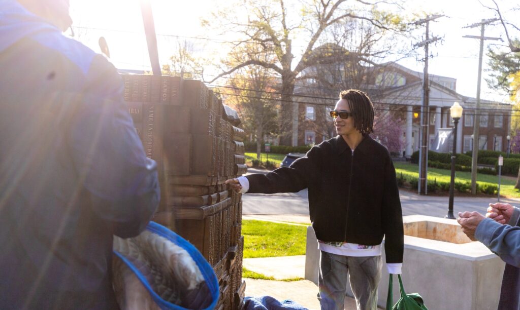 Memorial artist Sandy Williams IV observes the latest installation work.
