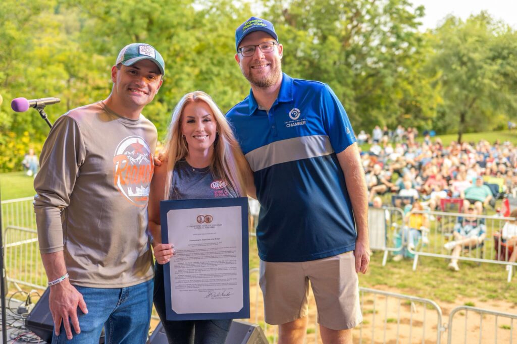 Waynette Anderson celebrates the passage of HJR 605 with Virginia House Delegate Sam Rasoul and Roanoke Chamber of Commerce president Eric Sichau.