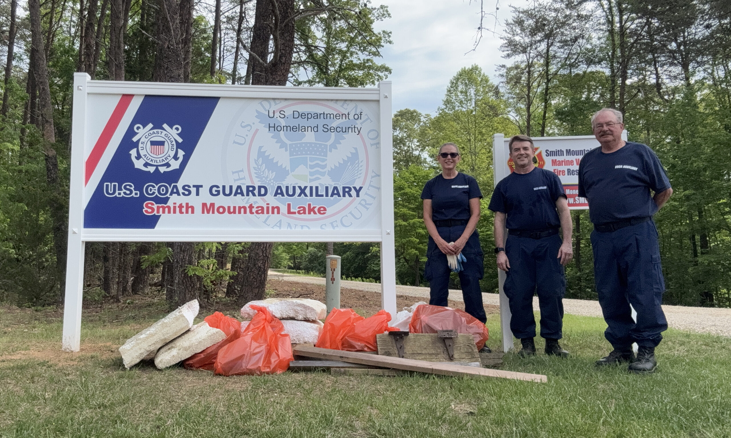 Volunteers from SML USCG Auxiliary Flotilla 81 take a break after clearing leaves, branches and other debris from the shoreline during a Take Pride in Smith Mountain Lake cleanup event in May.