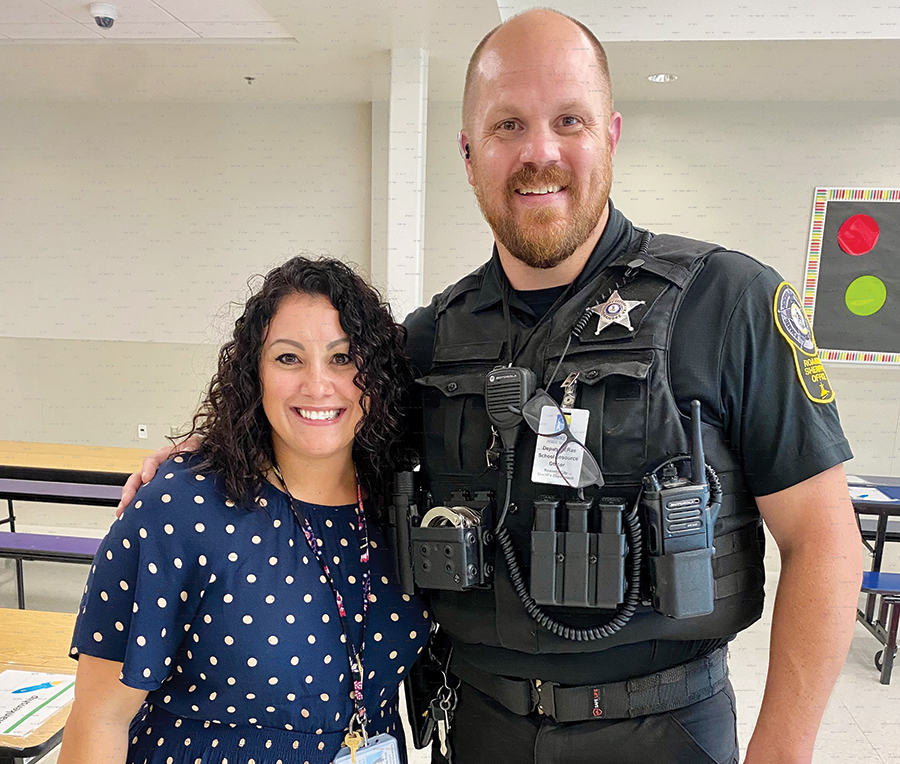 Dr. Brenda Russ, principal at Round Hill Elementary School, stands with an SRO.