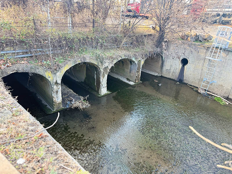 Trout Run and Lick Run spill into an open channel beside the East End shops along Campbell Avenue SE.