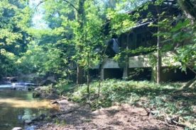 Pictured is the current state of the back of the structure that is located on the banks of Glade Creek.
