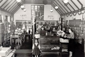 This 1950s image shows the interior of the library with Virginia Lee behind the main desk.