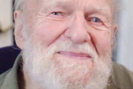The late Walter Rheinheimer’s warm smile, at Thanksgiving 2014, belies his serious mein.