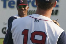 Members of the Salem Red Sox warm up for the game.