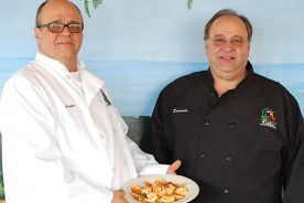 Carlos and Ricardo Amaral show off their popular dish Moqueca Mineira, a fish stew featuring an authentic Brazilian sauce.