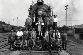 Thirteen-year-old Uldine Utley poses with N&W workers and others at the Roanoke Shops.