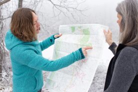 Emily Satterwhite, left, points out areas of Appalachia on a map that she expects to highlight as part of a $3 million project to commemorate the region's neglected history. Satterwhite and Katrina Powell, right, both faculty in the College of Liberal Arts and Human Sciences, are leaders of the project.