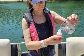 SMLA Water Quality Monitoring volunteer Carolyn Koontz bottles a water sample.
