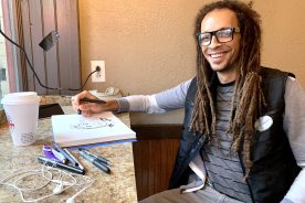 Evan Thomas Niemann sketching in one of his favorite spots: Mill Mountain Coffee & Tea.
