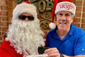 Bob Rotanz, owner of Mac and Bob's, poses for his Naughty Santa Claus photo.