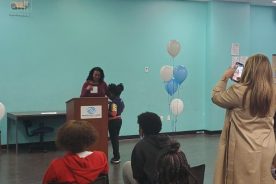 Roanoke Vice Mayor Patricia White-Boyd coaxes a shy 8-year-old winner from Salem, Markeysha Williams, up to the front to be recognized for a Black History Month Art Contest Award for a portrait of Mae Jemison. Markeysha took third place (there were three) final winners in the 15th Annual contest held by UScellular and the Boys & Girls Clubs of Southwest Virginia.