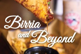 Signature birria tacos are served with a flavorful broth for dipping.